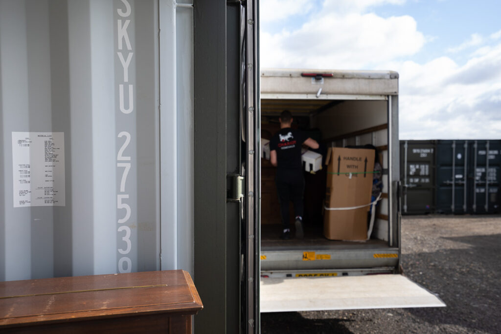Storage container and truck in the background for loading customers items